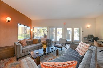 Community Clubhouse area with seating. Two couches available and several windows overlooking the property grounds.at Fountains of Fair Oaks, California, 95628
